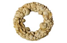 a wreath made out of shells on a white background