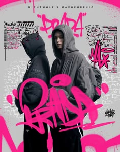 two young men standing next to each other in front of graffiti covered wall and one is wearing a hoodie