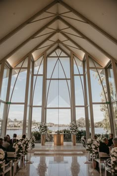 the inside of a church decorated with white flowers