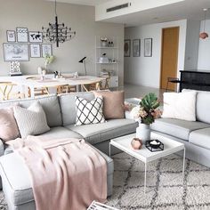 a living room filled with lots of furniture and decor on top of a white rug