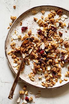 a bowl filled with granola and nuts on top of a table