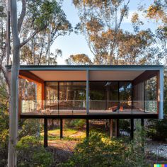 the house is surrounded by trees and has glass walls that allow natural light to enter