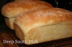 two loaves of bread cooling on a rack