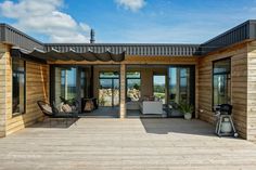 an outdoor living area with patio furniture and large windows