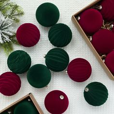 christmas ornaments are arranged in boxes on the table