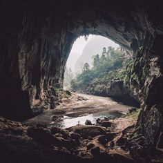 the entrance to a cave with water in it