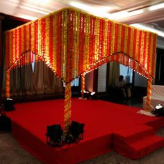 a red carpeted area with orange and yellow decorations