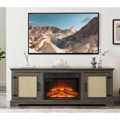 an entertainment center with a fire place in front of a flat screen tv mounted on the wall