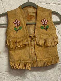 This child size smoked moose vest is circa 1950.  It was hand beaded by an Ojibwe artist and has a tie closure.  It measures 11 1/2" shoulder to shoulder and 15 1/2" down the back including the fringe. Thank you for your interest and support of a small business. WE DO NOT SHIP INTERNATIONALLY.  Free shipping only within the continental United States. Returns:  Carefully review the description of the item and the pictures.  If you have any questions, please ask before ordering.  We do not, in general, issue refunds, but may be considered on case-by-case basis.  Refund will not be issued until the item has been received and will be issued minus shipping or other costs as deemed necessary by the seller.  If a refund is requested not due to condition of item the seller has the prerogative to d Vest Sewing Pattern, Beaded Jacket, Sterling Silver Heart Pendant, Native American Beading, Silver Heart Pendant, Native American Indians, Hand Beading, American Made, Moose