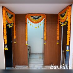 an entrance decorated with orange and yellow garlands