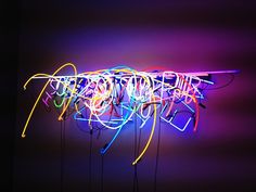 a neon sign that has many wires attached to it