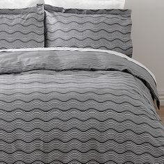 a bed with black and white waves on it