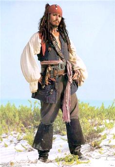 a man dressed as captain jack sparrow standing in the snow with his hands on his hips