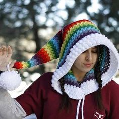 a woman wearing a multicolored crocheted hat