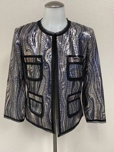 Add some sparkle to your wardrobe with this stunning silver and black sequin jacket from Caché. The jacket is made from high-quality polyester material, and is designed to fit women in size M. Its basic style makes it perfect for any occasion, while its metal theme and sequin accents give it a unique and eye-catching look. This jacket is brand new with tags, and is sure to become a beloved addition to your wardrobe. Whether you're dressing up for a night out, or simply want to add some glamour to your everyday look, this Caché jacket is the perfect choice. Black Sequin Jacket, Sequin Jacket, Brands Outlet, Basic Style, Black Sequins, Everyday Look, Polyester Material, Vest Jacket, Night Out