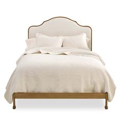 a bed with white linens and pillows on it's headboard, in front of a white background