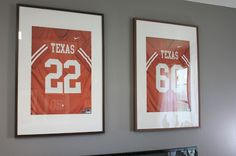 two framed texas football jerseys hang on the wall