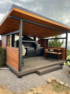 an outdoor kitchen and dining area on a deck