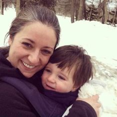 a woman holding a child in the snow