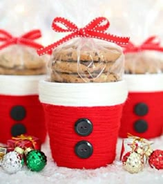 three red and white baskets filled with cookies in front of other christmas treats on a table