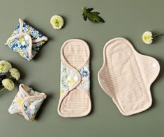 three baby bibs, one with flowers on it and the other with an oven mitt