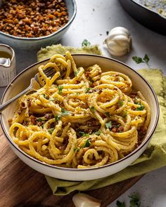 a bowl filled with pasta next to other dishes