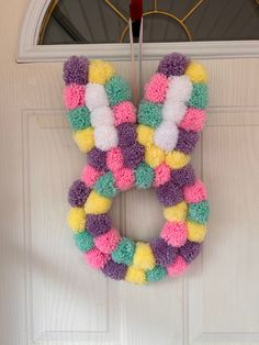 a colorful wreath hanging on the front door