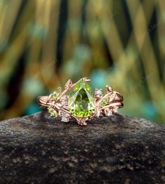 a green ring sitting on top of a rock