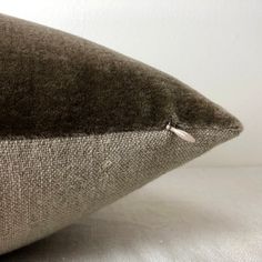 a close up of a pillow on a bed