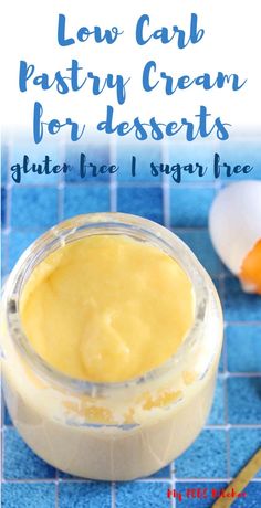 keto pastry cream in a glass jar on a blue counter with an egg next to it