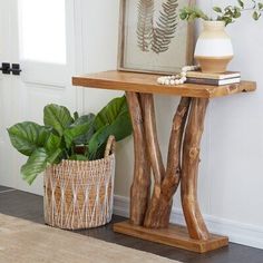 a wooden table sitting next to a potted plant