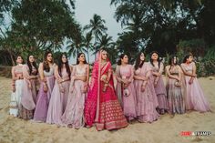 a group of women standing next to each other on a beach