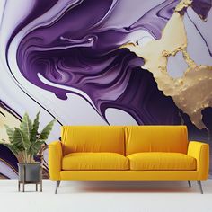 a yellow couch sitting in front of a purple and gold painting on the wall next to a potted plant