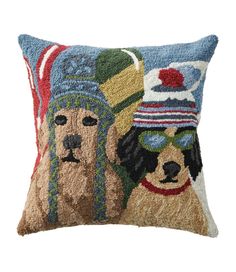 a pillow with two dogs wearing hats on it