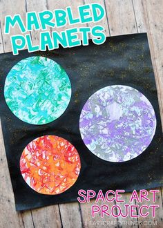 three painted circles sitting on top of a piece of black paper with the words marbled planets