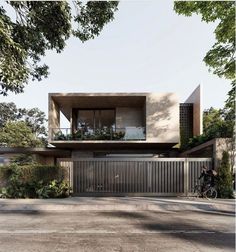 the house is surrounded by trees and greenery, with a bicycle parked in front