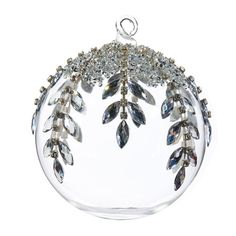 a glass ornament with leaves and crystals