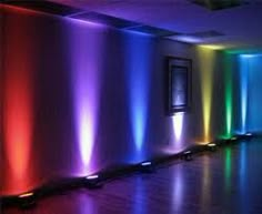 an empty room with colorful lights on the walls