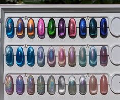 Create your own custom sets and have the futuristic nails of your holographic dreams with this listing. Get ready to get lost watching the colors shift and dance across your nails as you bring magic to everything you touch in these beauties!  Photos shown in full sun and in overcast conditions.  ~ Choose your own color from any of the cat eye, 9D holographic swatches shown. **Swatches are 2 coats, except #61-64, which are 3 coats for full coverage; Swatches 65-70 are shown in 2 coats over black to enhance the color shift visibility. Will be more sheer if made without black base.** ~ You can choose multiple colors to create a mix-mani, please be specific about which colors you would like on which nails. ~Add your sizes and color number(s) to the notes below and be sure to choose which shape Futuristic Nails, Nail Dipping Powder Colors, Gell Nails, Cat Eye Colors, Color For Nails, Sculpted Nails, Cat Eye Gel Polish, Galaxy Nails, Acrylic Press On Nails