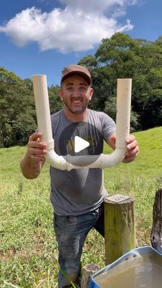 a man is holding two large tubes in his hands