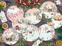 a table topped with lots of plates covered in christmas decorations