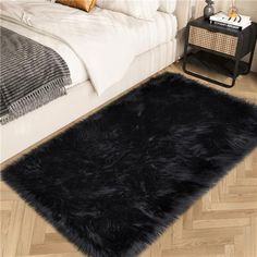 a black shaggy rug on the floor in a bedroom