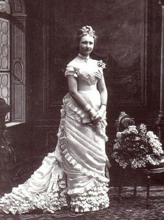 an old photo of a woman in a dress