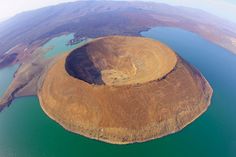 an island in the middle of a lake surrounded by land and water is seen from above