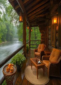 a porch with two chairs and a table on the deck next to a body of water