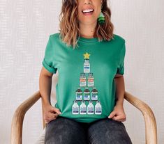 "Introducing the perfect shirt for nurses who love the holidays! Our exclusive design features a Christmas tree made entirely of medication bottles, because who needs ornaments when you've got Propofol, Ativan, Precedex, and Valium? This festive shirt is sure to bring a smile to your colleagues and patients alike. And don't worry, the medication bottles are all empty (we promise!). So spread some holiday cheer and show off your nursing pride with this hilarious and unique shirt. Happy Holidays and a healthy New Year! How To Order Your New Favorite Nurse T-Shirt: 1) Please, Check and Review all Photos. 2) Select Your T-shirt Size and Color. 3) Choose Your Quantity (as many as you want). 4) Click \"Go to Cart\" and Fill out payment information. 5) Click \"Checkout\" T-Shirt Description: ◆ PR Pharmacy Tech Shirt Ideas, Pharmacy Tech, Tech Shirt, Festival Shirts, Unique Shirt, Nursing Tshirts, Color Care, Pharmacist, Nursing Shirts