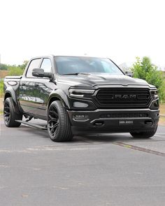 a black ram truck parked in a parking lot