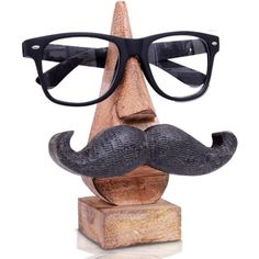 a wooden head with glasses and a fake mustache