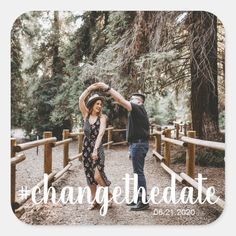 a couple dancing in the woods on their wedding day with change the date sticker