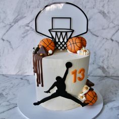 a birthday cake decorated with basketballs and the number 13 on it's side